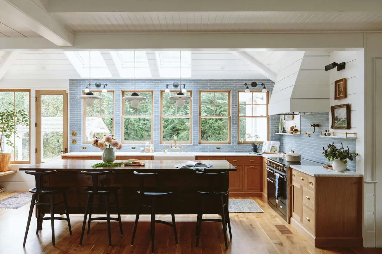 Minimalist Scandi-style kitchen with light oak wood finishes, white marble countertops, and an airy open-plan layout—modern vacation home in Coimbatore.