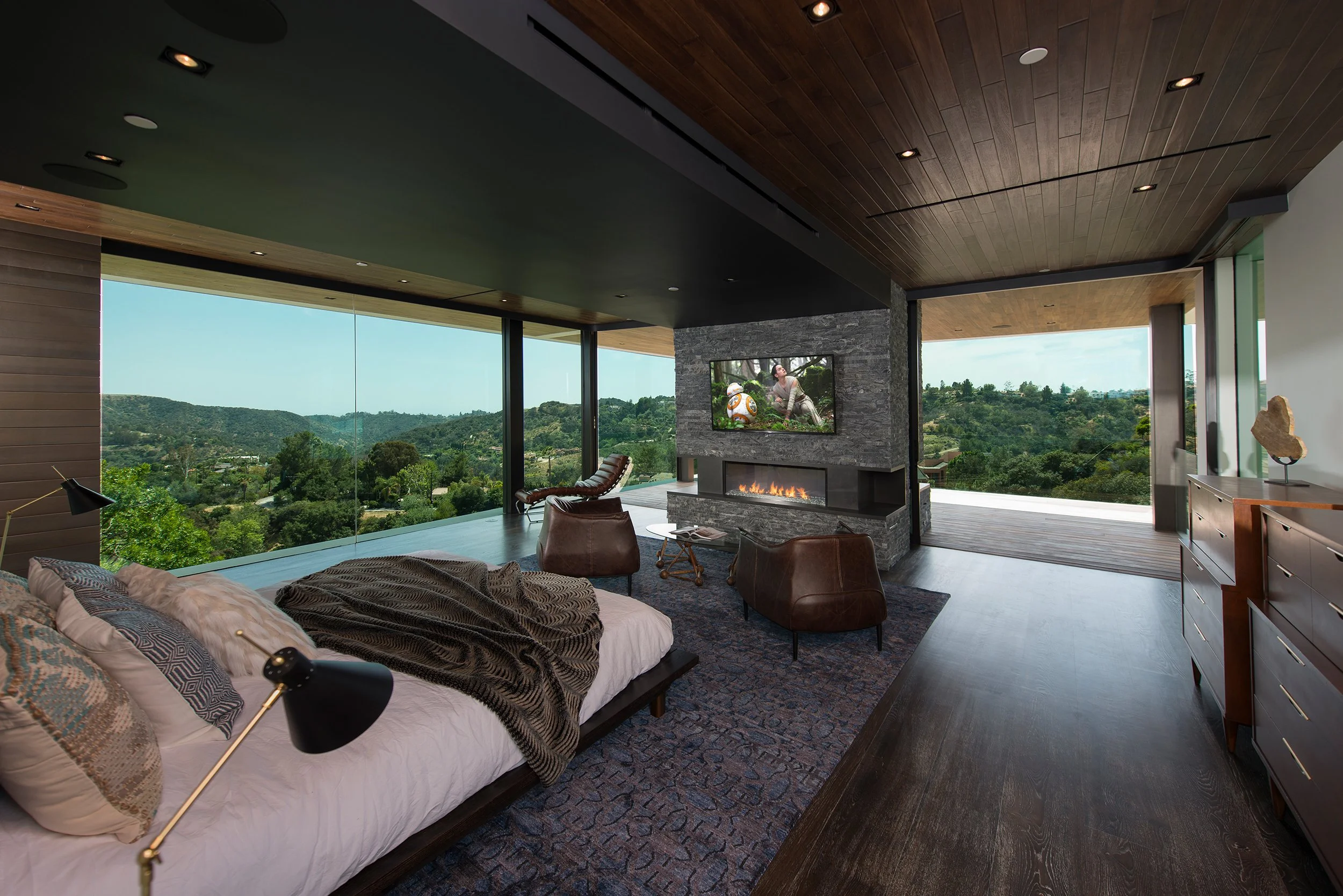 Modern glass-walled master bedroom with floor-to-ceiling windows and mountain views—luxury NRI suite in Anaikatti, Coimbatore.